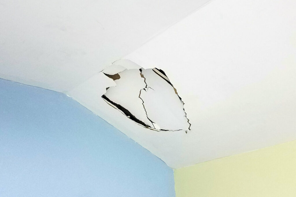 Damaged drywall ceiling requiring repair.