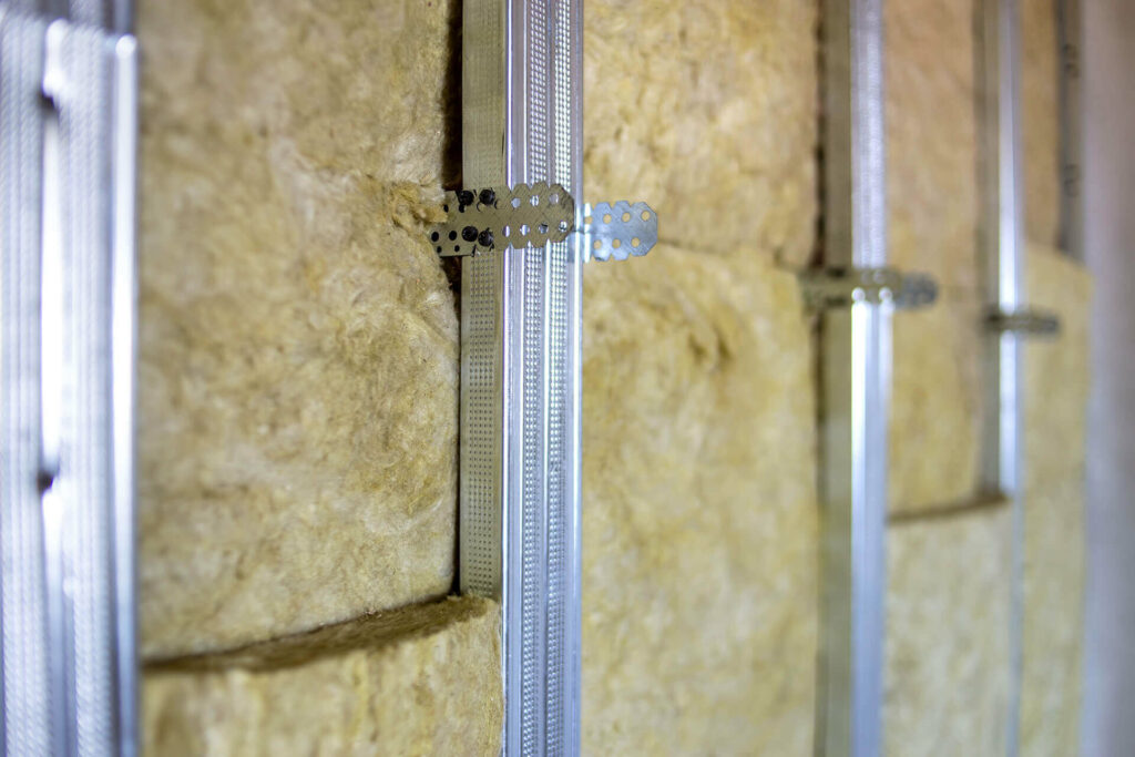 Mineral wool insulation installed between steel studs.